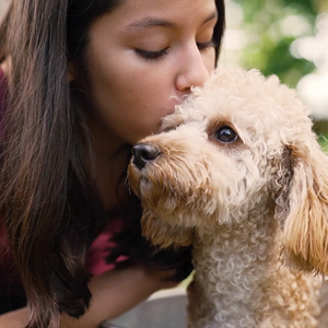 Girl kissing puppy